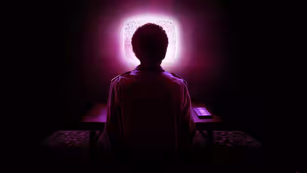 A seated figure faces a glowing television in a dark room