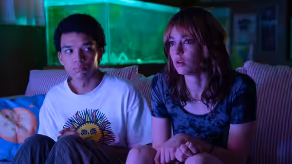 Owen (Justice Smith) and Maddy (Jack Haven) sit together, watching something offscreen