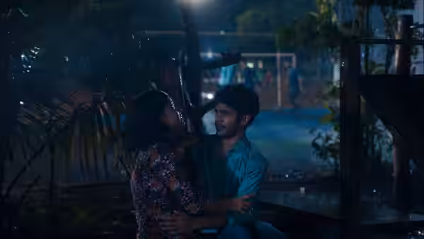 Anu (Divya Prabha) embraces Shiaz (Hridhu Haroon) beneath a shelter in the rain