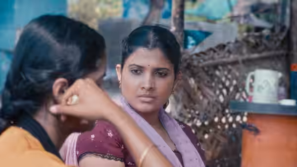 Parvaty (Chhaya Kadam) listens to a woman speaking beside her