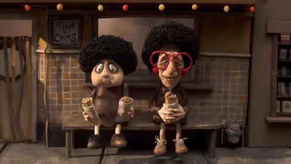 Two characters eat ice cream on a bench outside a fish and chips shop