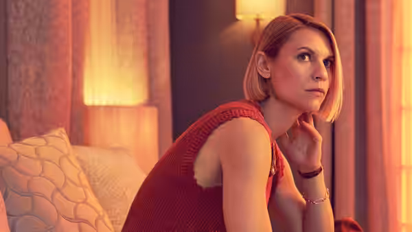 Rachel (Claire Danes) sits on a sofa, resting her hand against her cheek