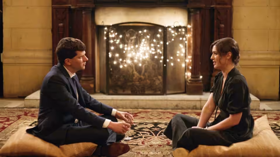 Toby (Jesse Eisenberg) and Rachel (Claire Danes) sit facing each other before a fireplace