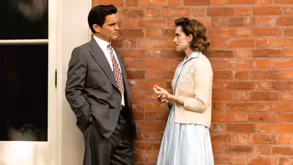 Hawk Fuller (Matt Bomer) talks with Lucy Smith (Allison Williams) beside a brick wall