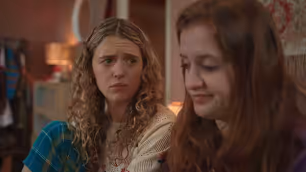 Carrie watches Jen with concern as they sit together in a living room