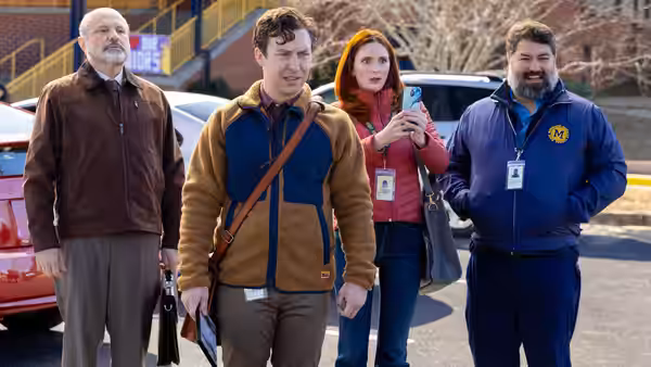 Evan Marquez, Gwen Sanders and Markie Hillridge walk through a school parking lot with an older man
