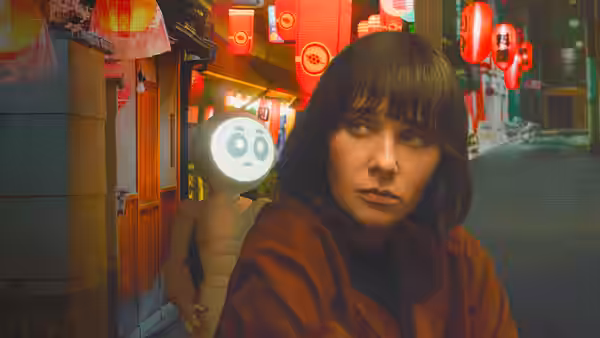 Suzie (Rashida Jones) looks back on a lantern-lit street, with Sunny behind her