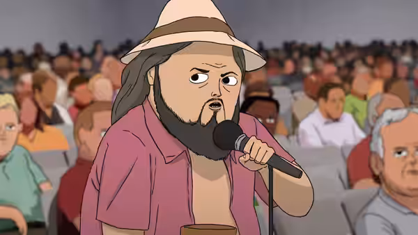 Marshall Cuso (Dave King) speaks into a microphone before a seated crowd