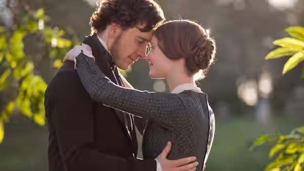 Jane Eyre (Mia Wasikowska) and Edward Rochester (Michael Fassbender) embrace in a garden