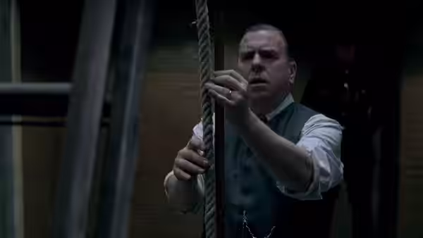 Albert Pierrepoint (Timothy Spall) adjusts a hanging rope in the execution chamber