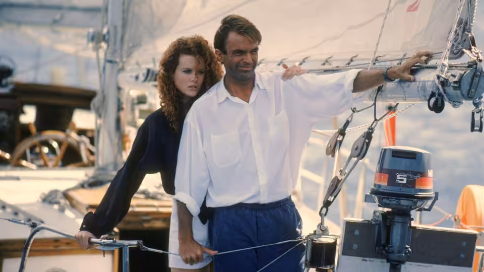 Rae Ingram (Nicole Kidman) stands beside John Ingram (Sam Neill) aboard their sailboat