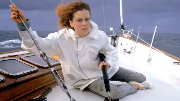 Rae Ingram (Nicole Kidman) sits on the sailboat deck, gripping a line and a gun