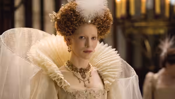 Elizabeth I (Cate Blanchett) faces forward in a white ruff and jeweled gown