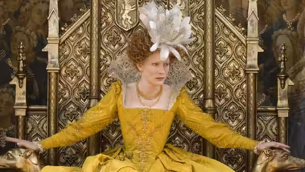 Elizabeth I (Cate Blanchett) sits on an ornate throne in a yellow gown