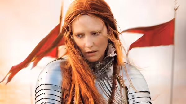 Elizabeth I (Cate Blanchett) wears armor as red flags fly behind her