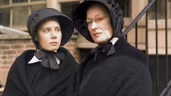 Sister James (Amy Adams) and Sister Aloysius (Meryl Streep) stand outside the school