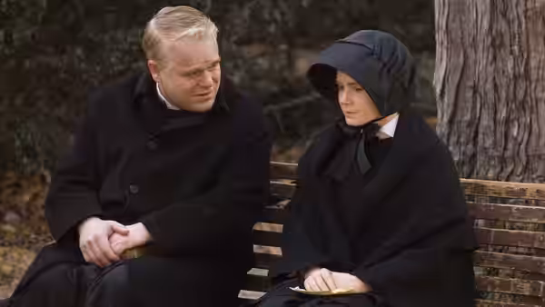 Father Flynn (Philip Seymour Hoffman) speaks with Sister Aloysius (Meryl Streep) on a bench