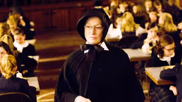 Sister Aloysius (Meryl Streep) watches students studying in the school classroom