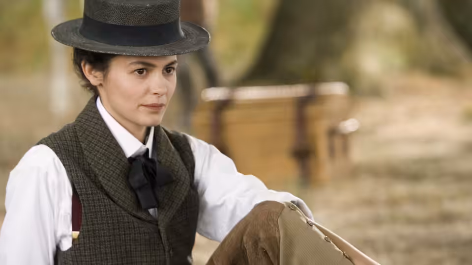 Gabrielle 'Coco' Chanel (Audrey Tautou) in a riding hat and vest, seated outdoors