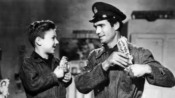 Bruno smiles as a uniformed man shows him a paper slip