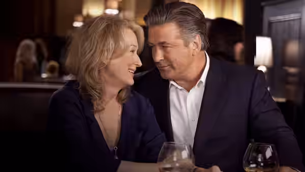 Jane Adler (Meryl Streep) and Jake Adler (Alec Baldwin) lean close over drinks at a restaurant