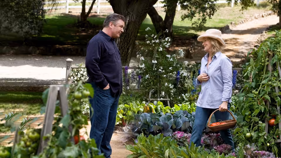 Jane Adler (Meryl Streep) talks with a man among plants in her garden