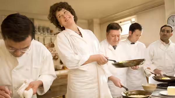 Julia Child (Meryl Streep) cooks with students in a professional kitchen