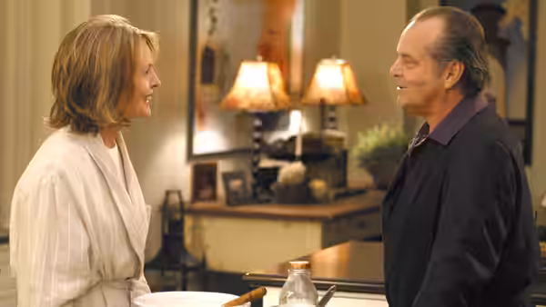 Erica Barry and Harry Sanborn talk across a kitchen island
