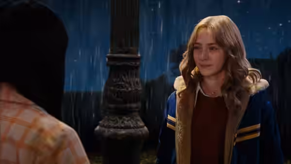 Susie Salmon (Saoirse Ronan) faces a young man beside a carved pillar in the rain