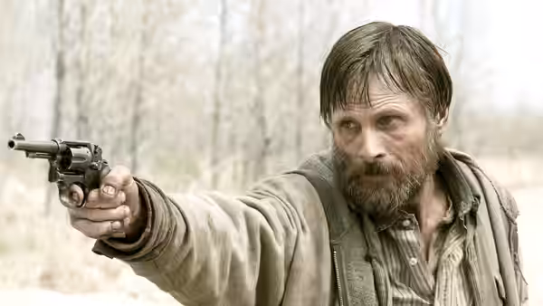 The Father aims a revolver into the woods
