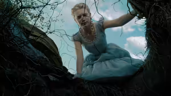 Alice (Mia Wasikowska) leans over the edge of a hole, peering down