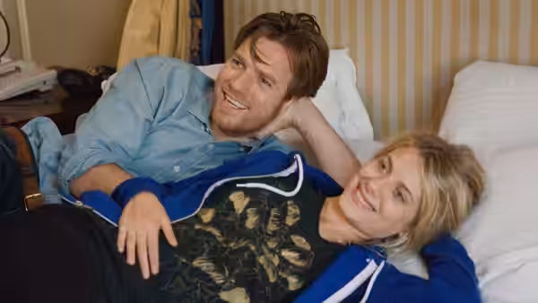 Oliver (Ewan McGregor) and Anna (Mélanie Laurent) recline together on a bed