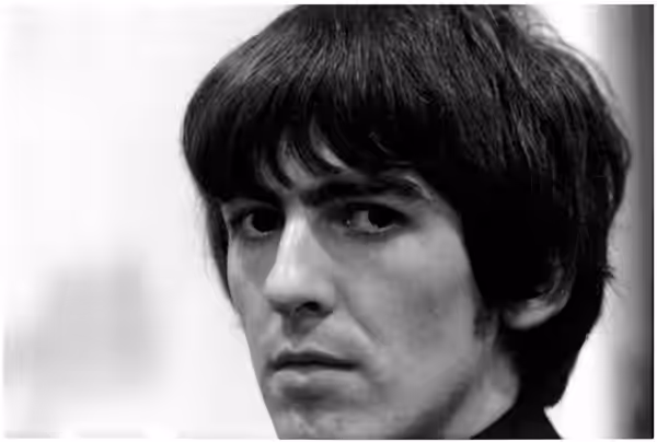 George Harrison looking toward the camera in a black-and-white close-up