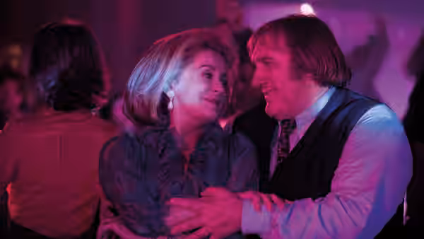 Suzanne Pujol (Catherine Deneuve) and Maurice Babin (Gérard Depardieu) embrace at a purple-lit party