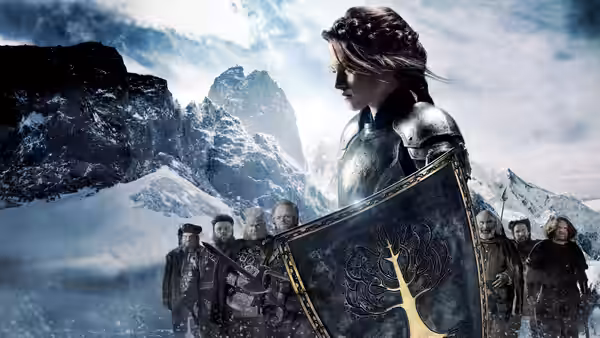 Snow White (Kristen Stewart) holds a shield as dwarves gather in the snowy mountains