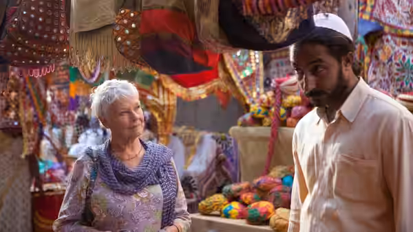 Muriel Donnelly (Maggie Smith) browses a colorful market beside Sonny Kapoor (Dev Patel)