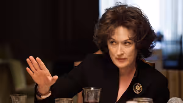 Violet Weston (Meryl Streep) gestures across the dining table