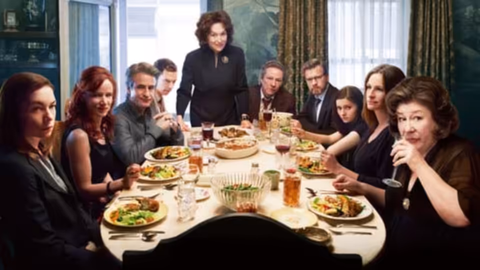 Violet Weston (Meryl Streep) stands behind her family gathered around a dining table
