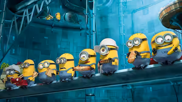 Minions ride a conveyor through a vast blue industrial chamber