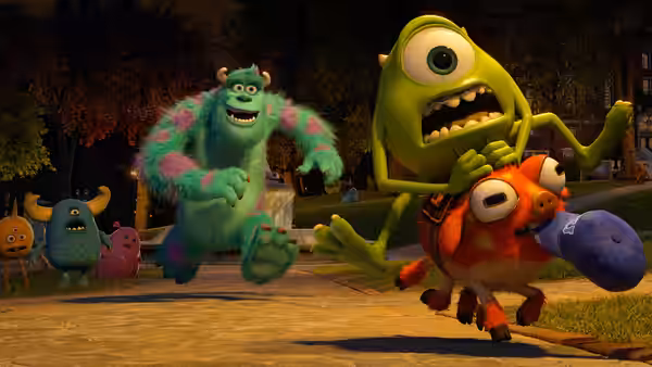 Mike flees with a smaller monster as Sullivan and other monsters chase them