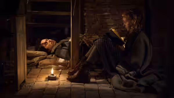 Liesel Meminger (Sophie Nélisse) reads beside Max Vandenburg (Ben Schnetzer) in their cellar