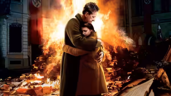 Hans Hubermann (Geoffrey Rush) embraces Rosa Hubermann (Emily Watson) before a burning pile of books