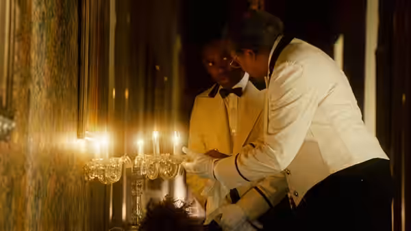 Cecil Gaines (Forest Whitaker) and another butler arrange candles on a White House mantel