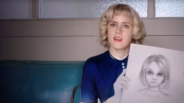 Margaret Keane (Amy Adams) holds up a drawing of a large-eyed girl