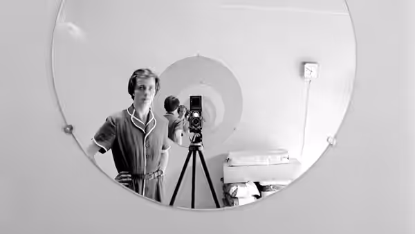 Vivian Maier poses with her camera in a mirror self-portrait