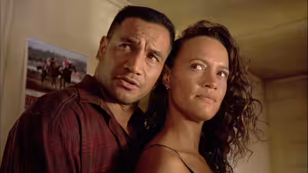 Jake Heke (Temuera Morrison) and Beth Heke (Rena Owen) stand close together looking ahead
