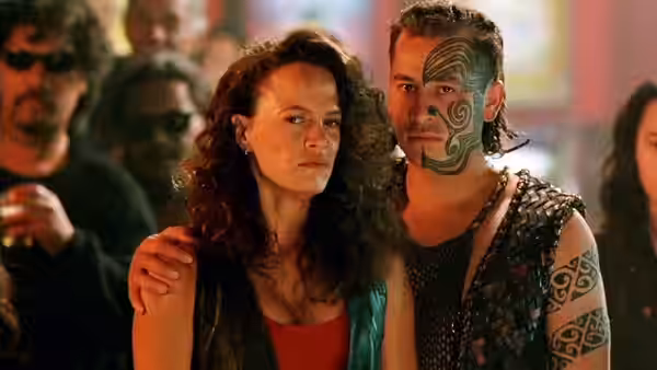 Beth Heke (Rena Owen) stands with Jake Heke (Temuera Morrison) whose arm rests on her shoulder