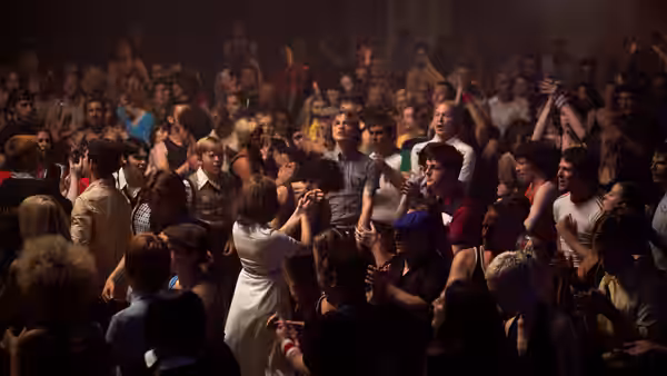 A crowded dance floor of young people moving to the music