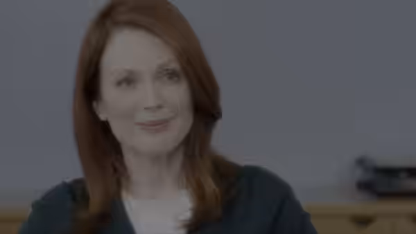Alice Howland (Julianne Moore) smiles while seated indoors