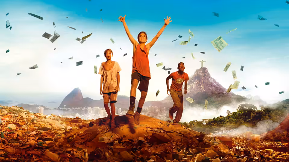 Three boys stand atop a rubbish heap as papers fly around them
